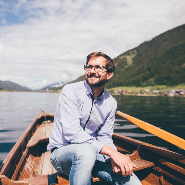 Mann sitzt im Boot auf dem Wasser | © Urlaub am Bauernhof Kärnten / Daniel Gollner