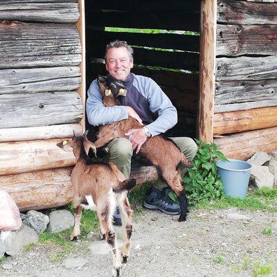 Mann umarmt Ziegen | © Urlaub am Bauernhof Österreich