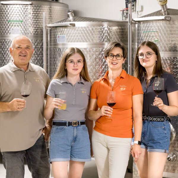 The farmhouse owners and their family provide wine and juice tastings in the cellar, surrounded by stainless steel fermentation tanks.