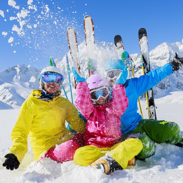 Guests engaging in winter activities in the snowy mountains, highlighting opportunities near the Farm House.