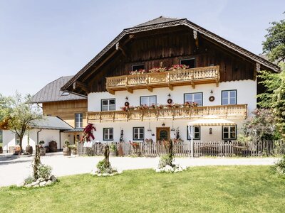 Exterior view of the Appartements building with traditional architecture, wooden balconies, and flower boxes.